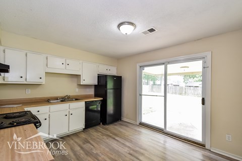 A kitchen with a Vinebrook Homes logo.