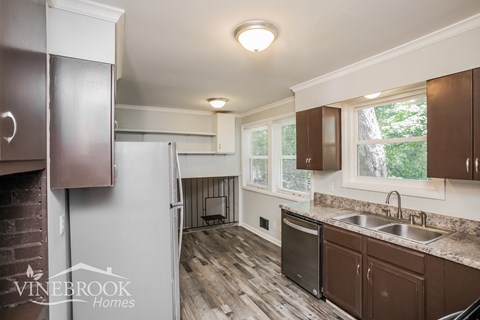 a kitchen with wooden cabinets and stainless steel appliances