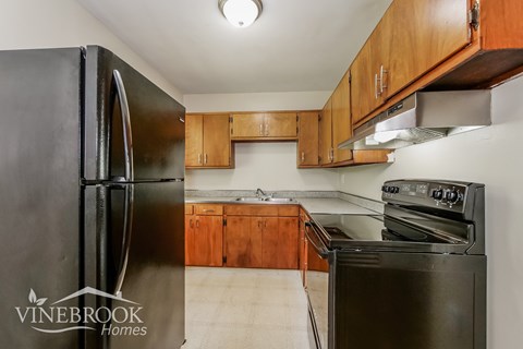 a kitchen with stainless steel appliances and wooden cabinets