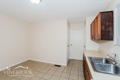 A kitchen with a sink and cabinets.