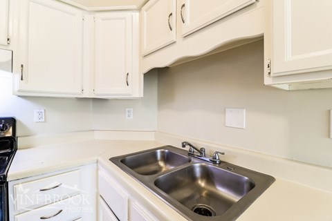 A kitchen with a sink and cabinets.