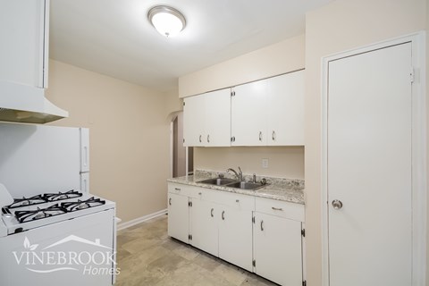 A kitchen with a Vinebrook Homes logo.
