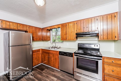 A kitchen with wooden cabinets and stainless steel appliances.
