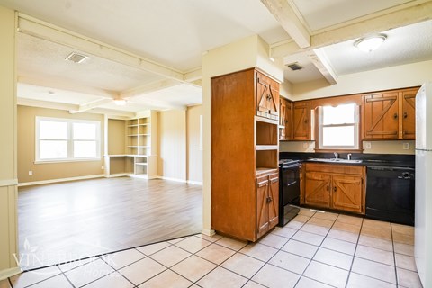 A kitchen with wooden cabinets and a black stove top oven.
