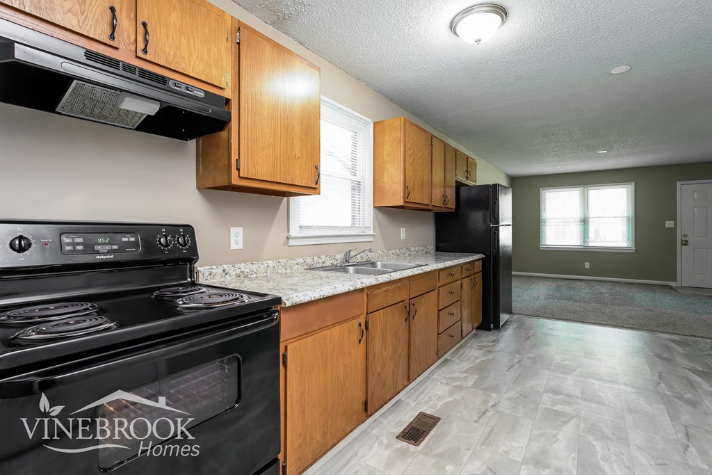 A kitchen with a Vinebrook Homes stove.