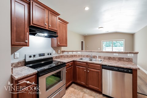 A kitchen with a stove top oven and a dishwasher.
