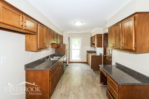 A kitchen with wooden cabinets and a countertop.