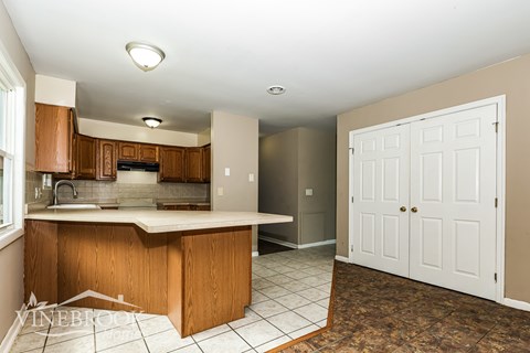 A kitchen with brown cabinets and a white door.