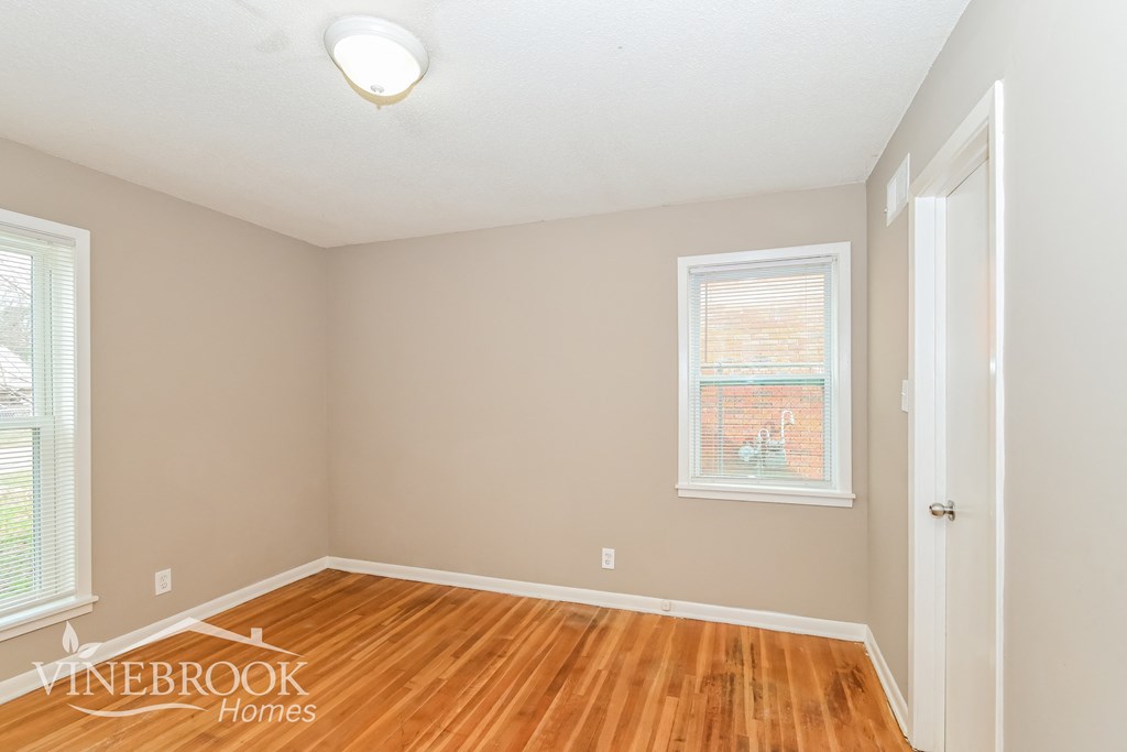 A room with a window and a door.