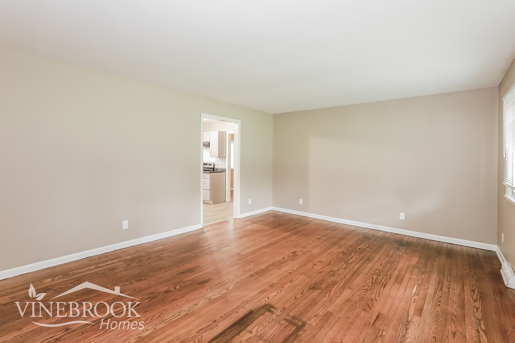 the living room and dining room with hardwood flooring