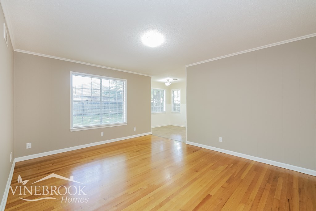 the living room and dining room with hardwood flooring