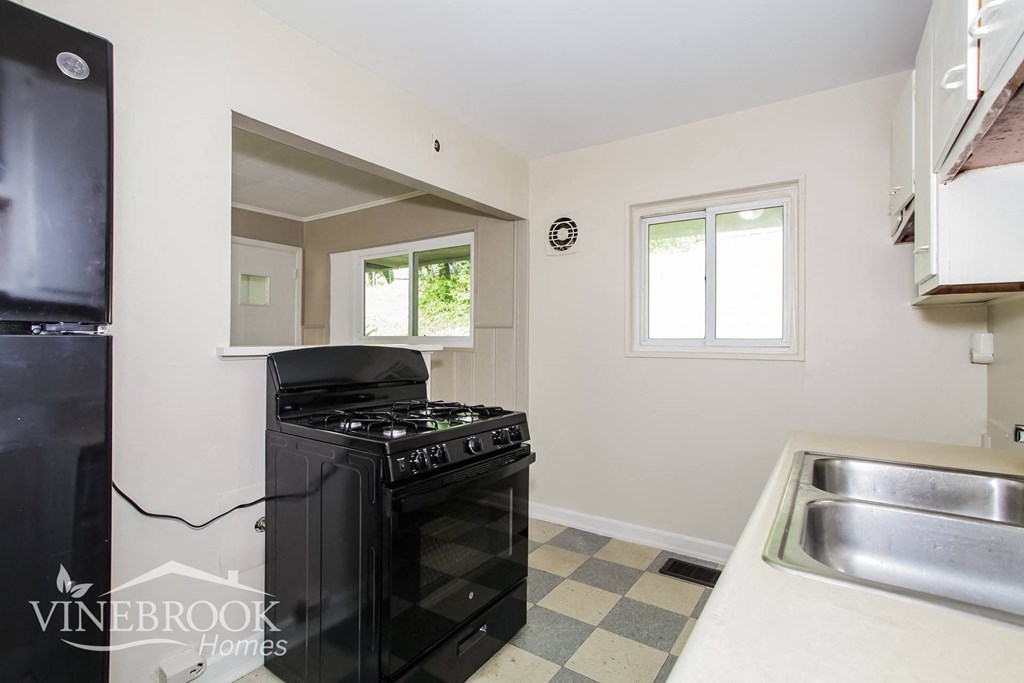 a kitchen with a stove and a sink