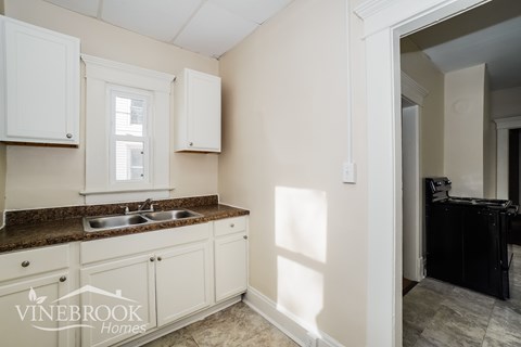 A kitchen with a sink and cabinets.