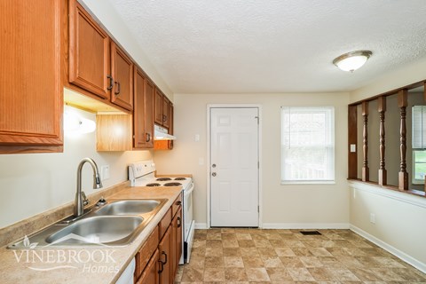 A kitchen with a sink and a toaster.