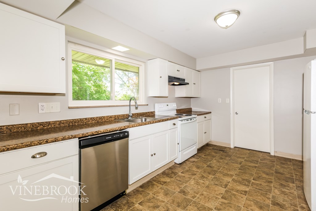 A kitchen with a Vinebrook Homes logo.