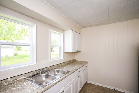 A kitchen with a sink and cabinets.
