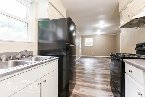 A kitchen with a black fridge and stove.