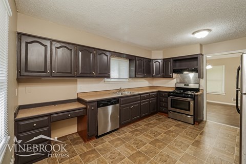 A kitchen with Vinebrook Homes logo.