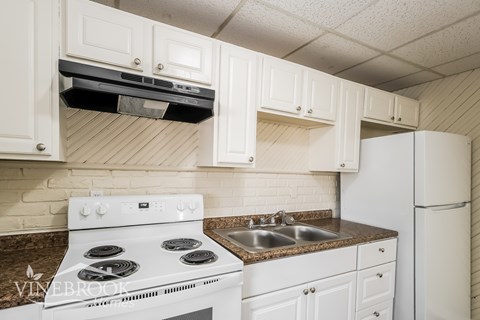 A white stove and sink in a kitchen.