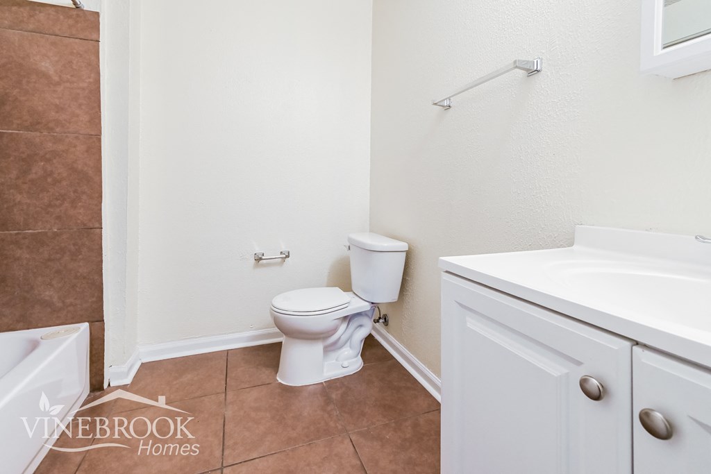 a bathroom with a toilet and a sink and a mirror