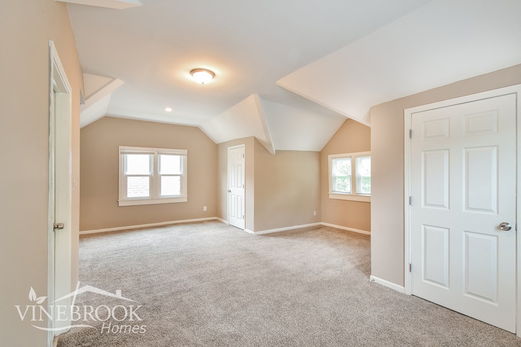 a bedroom with a carpeted floor and a white door
