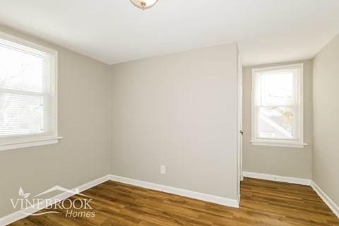 A room with a Vinebrook Homes logo on the bottom left corner.