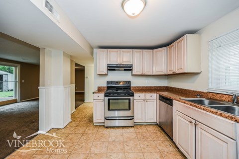 A kitchen with a Vinebrook Homes logo.