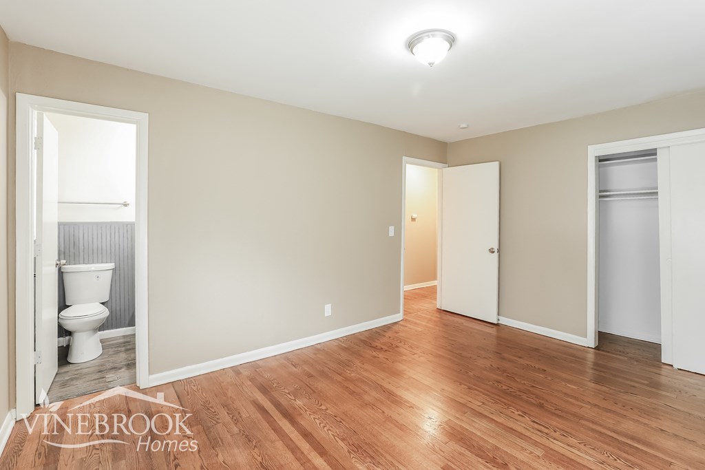 a renovated living room with a toilet and a door to a bathroom