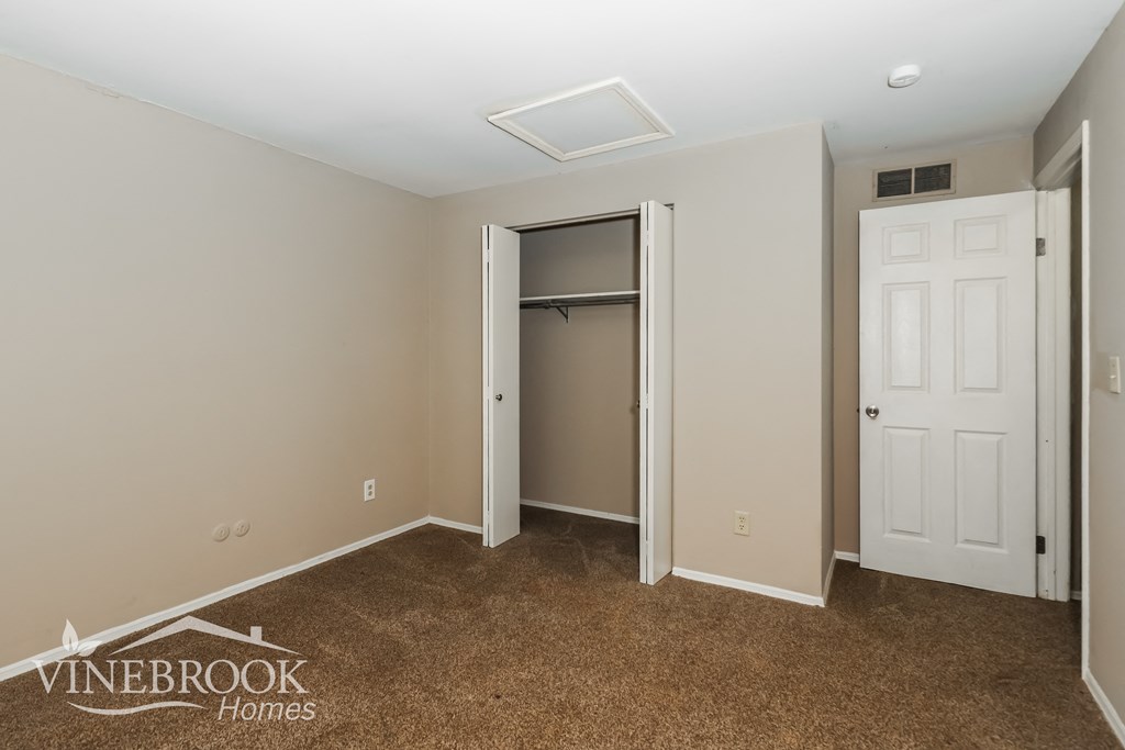 a bedroom with a closet and a door to a closet