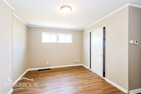 A room with a window and a door is shown.