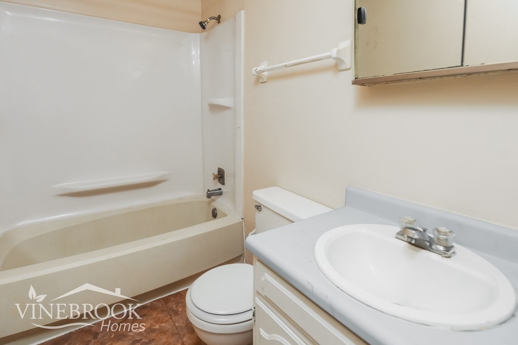 a bathroom with a sink toilet and a bath tub