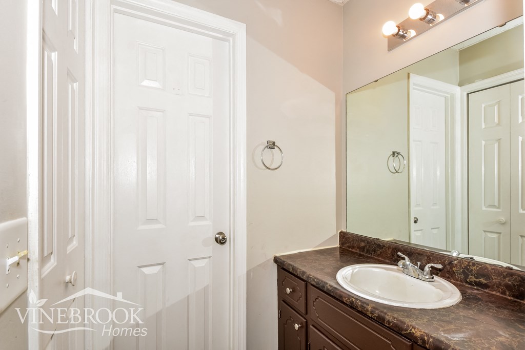 a small bathroom with a sink and a mirror