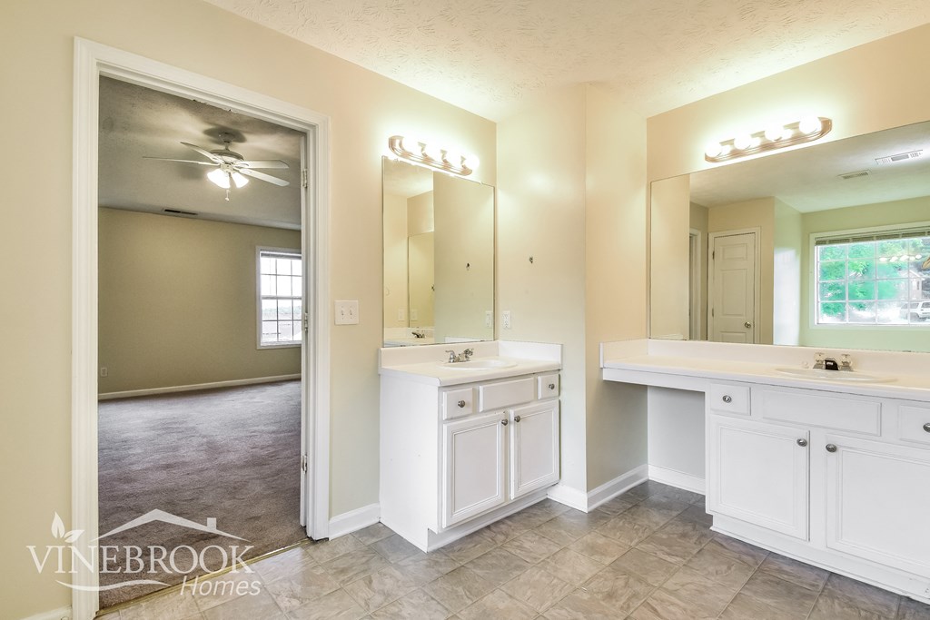 a bathroom with two sinks and a large mirror