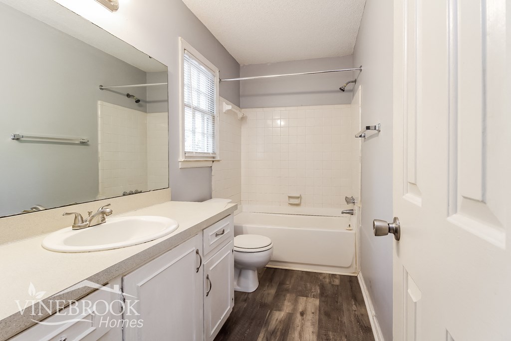 a white bathroom with a sink and a toilet