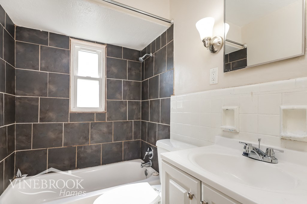 a bathroom with a sink and a bath tub and a mirror
