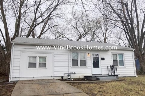a small white house with the words vine brook homes on it