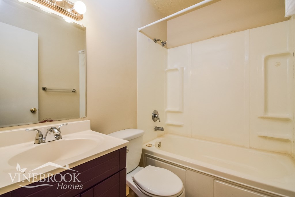 a bathroom with a sink toilet and a tub