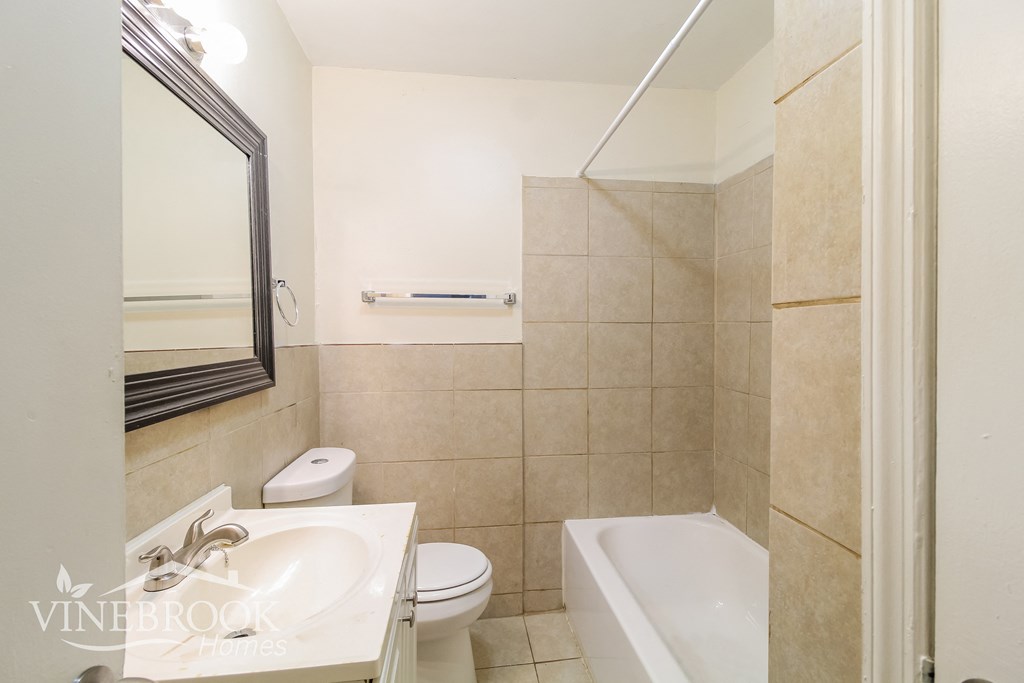 a bathroom with a sink and a toilet and a tub