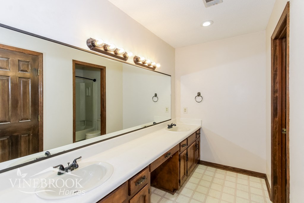 two sinks in a bathroom with a large mirror
