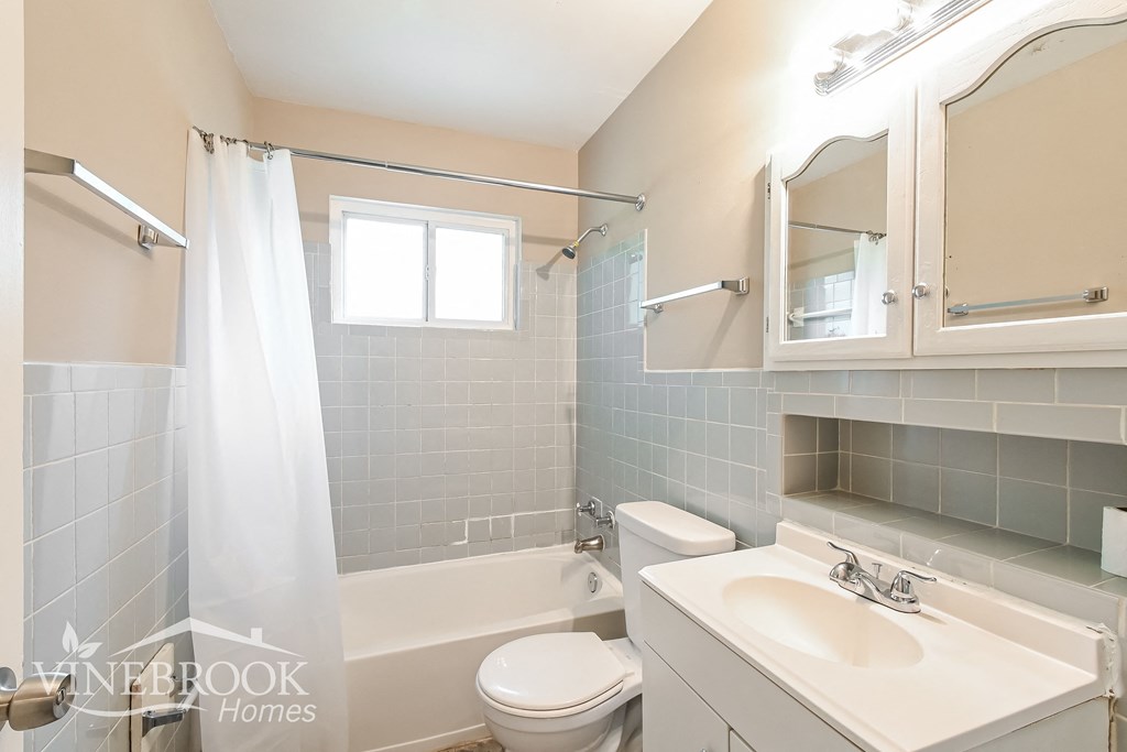 a bathroom with a sink toilet and a bath tub