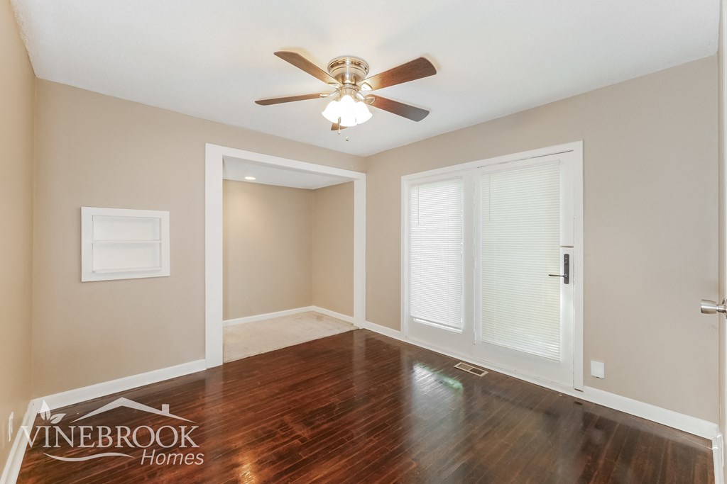 a living room with hardwood floors and a ceiling fan