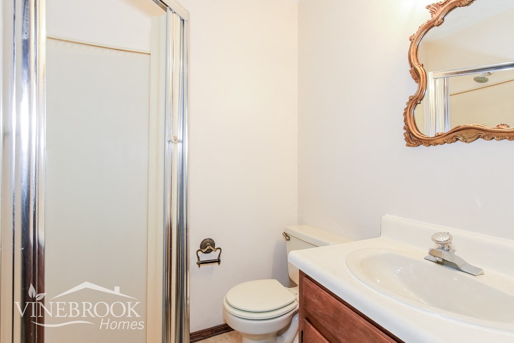 a bathroom with a toilet sink and a shower