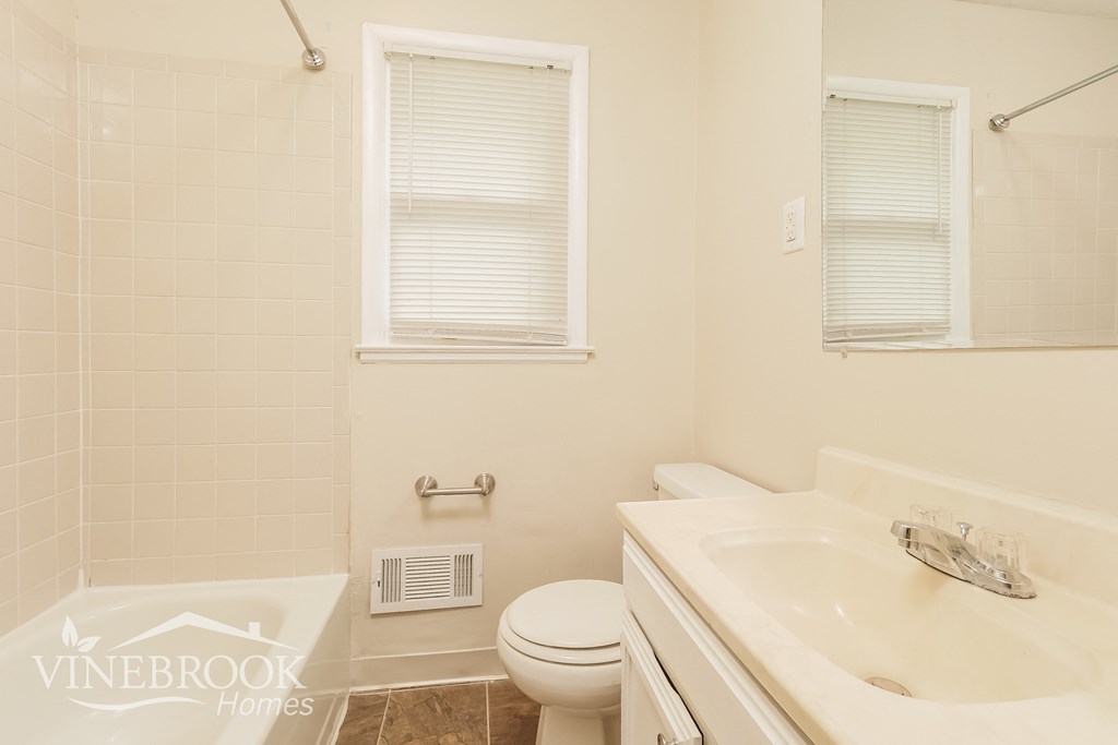 a white bathroom with a toilet sink and tub and a shower