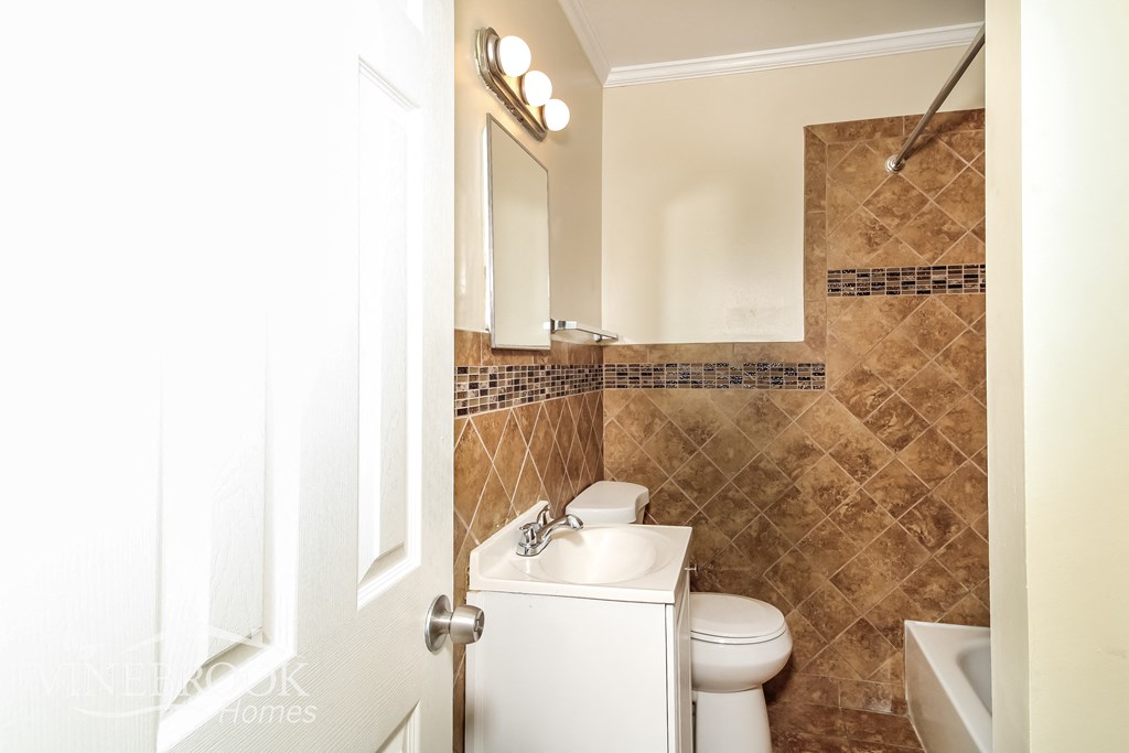 a bathroom with a toilet and a sink and a mirror