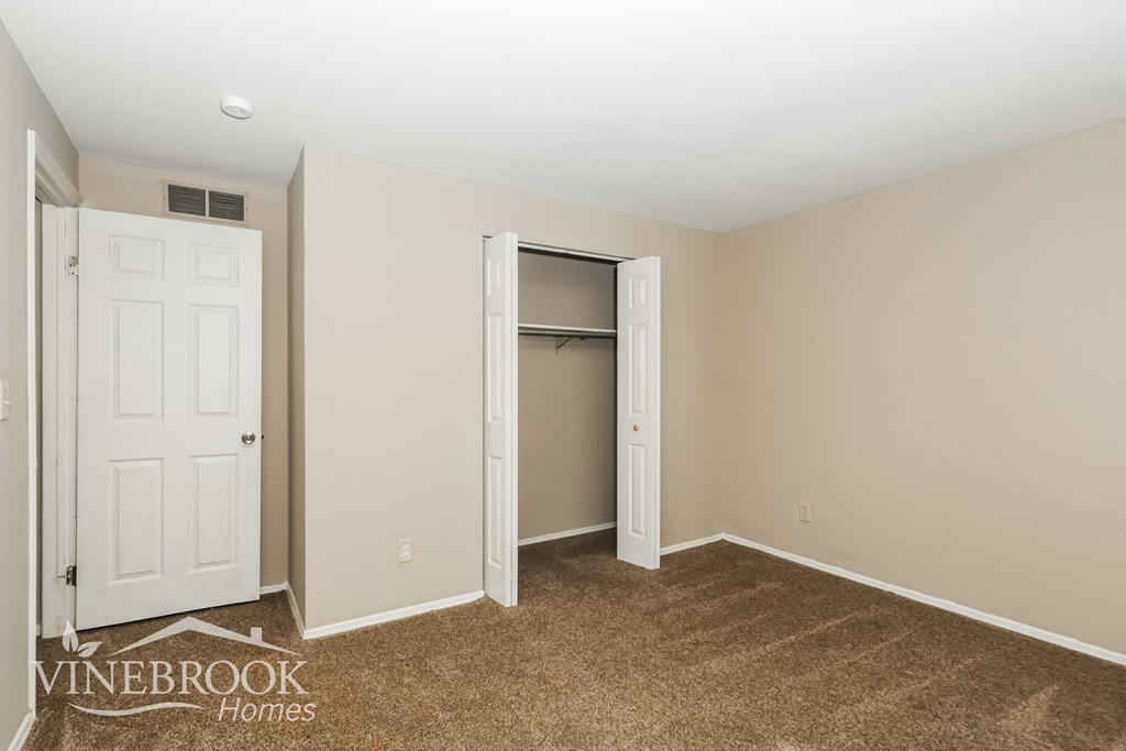 a bedroom with a closet and a door to a closet