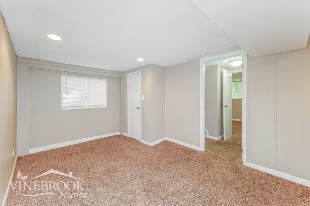 a bedroom with a carpeted floor and white walls