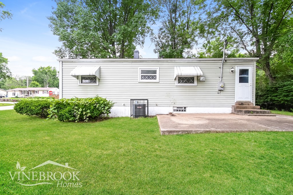 a white house with a yard and a driveway