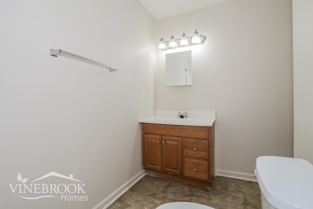 a small bathroom with a sink toilet and a mirror