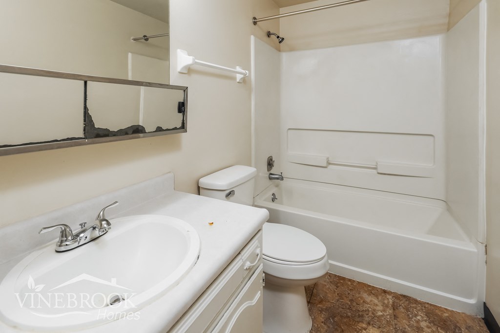 a bathroom with a sink toilet and a bath tub