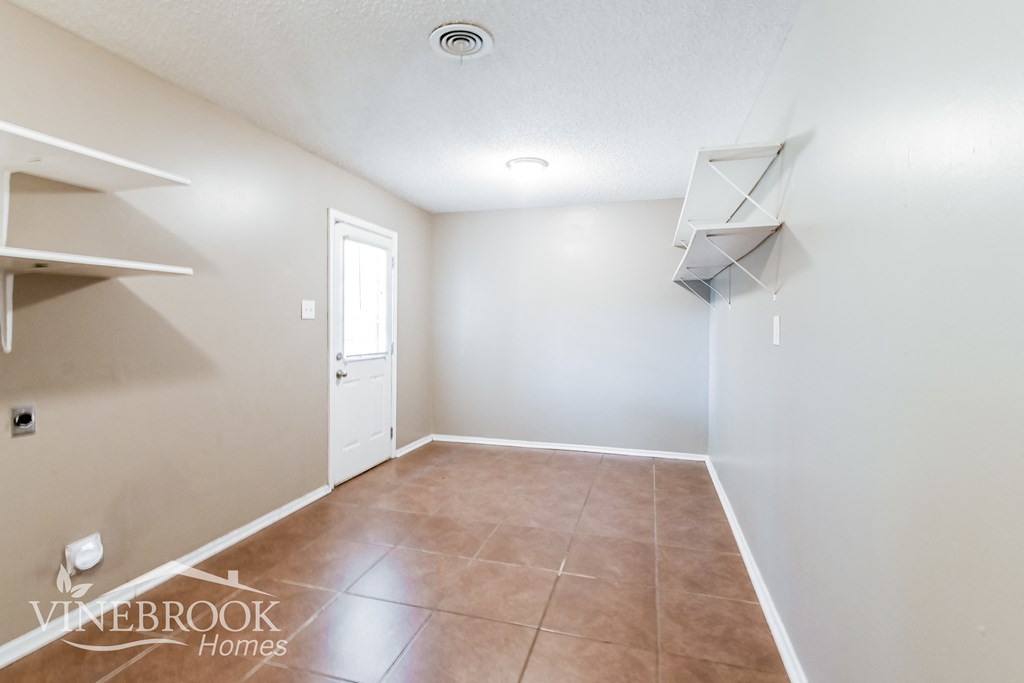 an empty room with a closet and a door